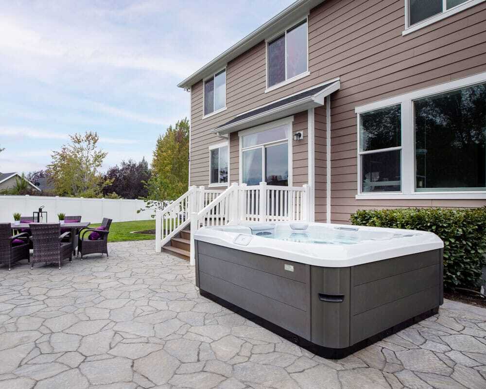 A Bullfrog Spa from the X Series, showcasing its contemporary design and functionality in a beautiful home